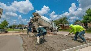 Construction workers laying a concrete foundation for a residential driveway installation project in Eastern North Carolina.